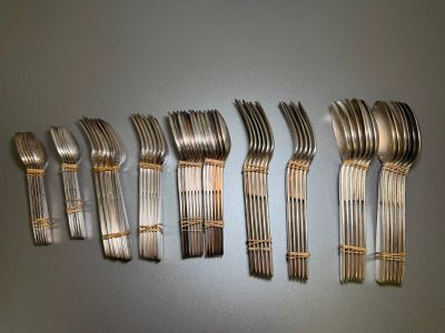 a lot of forks that are lined up on a table