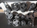 a lot of weights on a rack in the gym