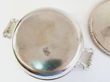 a silver plate with a picture of a man on it and a silver plate with a picture of a man on it