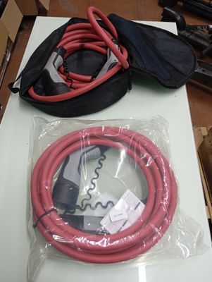 a red hose and a black bag sitting on a table