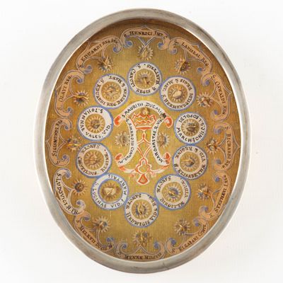 a gold plate with a design on it on a white surface