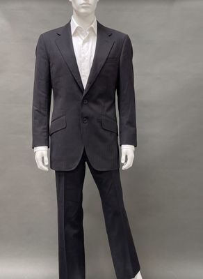 an image of a mannequin dressed in a black suit and white shirt