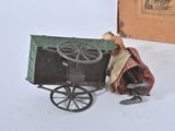 a small toy horse pulling a wagon with a man in it