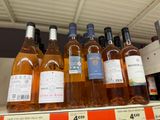 many bottles of wine sitting on a shelf in a store