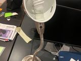 a desk with a lamp on it and a laptop on the desk