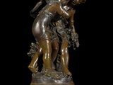 an image of a bronze statue of a woman holding a child