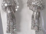 pair of diamond and white gold earrings on display on a mannequin