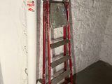 a ladder leaning against a wall next to a window