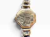 an image of a close up of a watch on a white surface