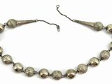 a close up of a necklace with silver beads on a white background
