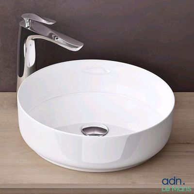 a white sink with a chrome faucet on a wooden counter