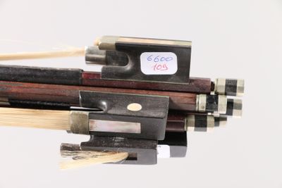 a close up of a violin bow with a stick in it