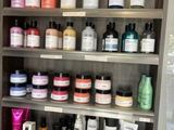 many different types of hair products on the shelves