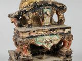 an image of a statue of a man sitting on top of a table