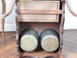 a wooden table with two pots and pans on it