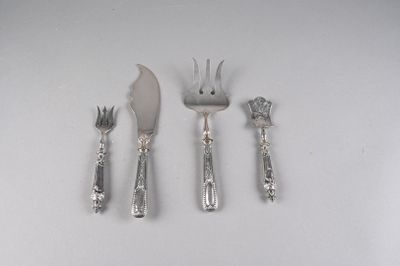 three forks, a knife, and a spoon on a table