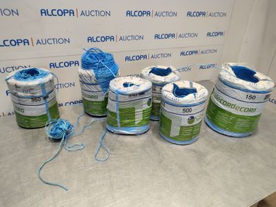 many rolls of blue and green yarn on a table