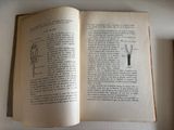 an open book on a table with a drawing on it