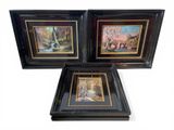 three framed paintings of animals and trees in a black frame