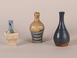 three vases sitting next to each other on a table