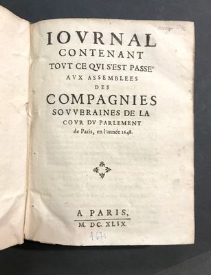an open book with black writing on it sitting on top of a table