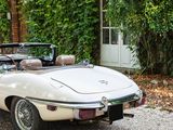 a white convertible car parked in front of a house