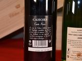 two bottles of wine sitting on a table next to each other