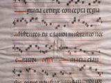 an old manuscript with writing on it and a pen in the middle of it