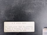 the back of a black laptop computer sitting on top of a white surface