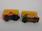 two toy trucks sitting next to each other on a table