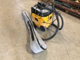 a yellow and black vacuum and a pair of skis on the floor