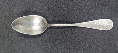 a spoon that is sitting on a black surface