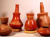 five different vases sitting next to each other on a table
