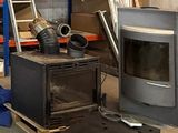 a small stove sitting in the middle of a room