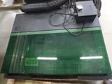 an image of a green glass table top with a blow dryer on it