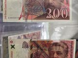 two pieces of paper money sitting on top of each other