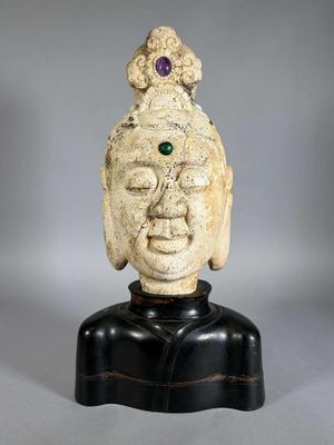 a close up of a statue of a person wearing a hat