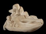 a statue of a woman laying down on a pillow