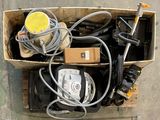 a box full of assorted electrical equipment on the ground
