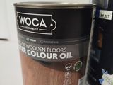 a can of wood floor oil next to a can of paint