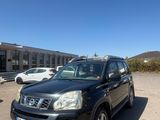 the black car is parked in the parking lot next to the building