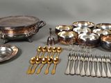a lot of silverware on a table with spoons and forks