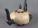 a black and white teapot with a cat on it