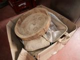 a cardboard box with a wooden plate inside of it