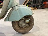 a scooter that is sitting on the floor in the garage