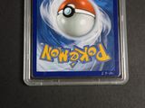 the pokemon card is in a plastic holder on a table