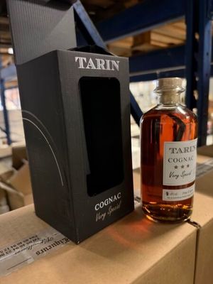 a bottle of cognac next to a cardboard box