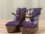 an image of a pair of purple shoes on a wooden table