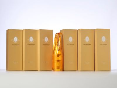 several boxes of perfumes are lined up on a white surface