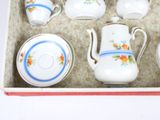 a box with a tea set in it on a table